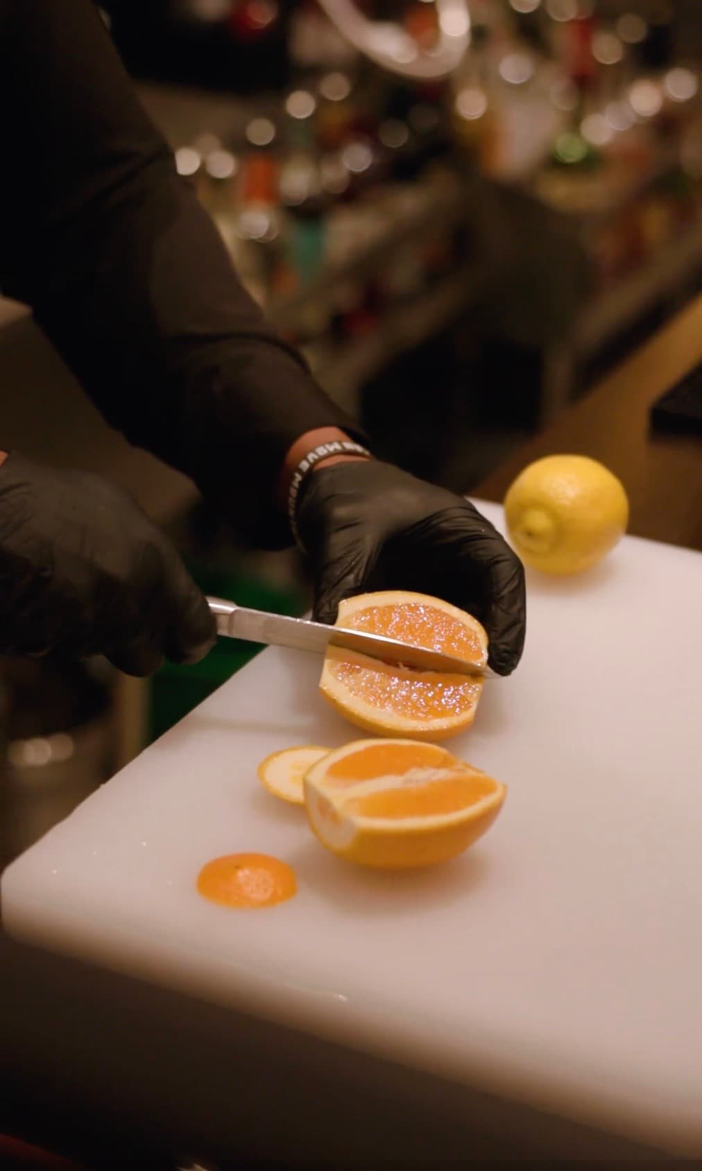 Bartender slicing fresh citrus