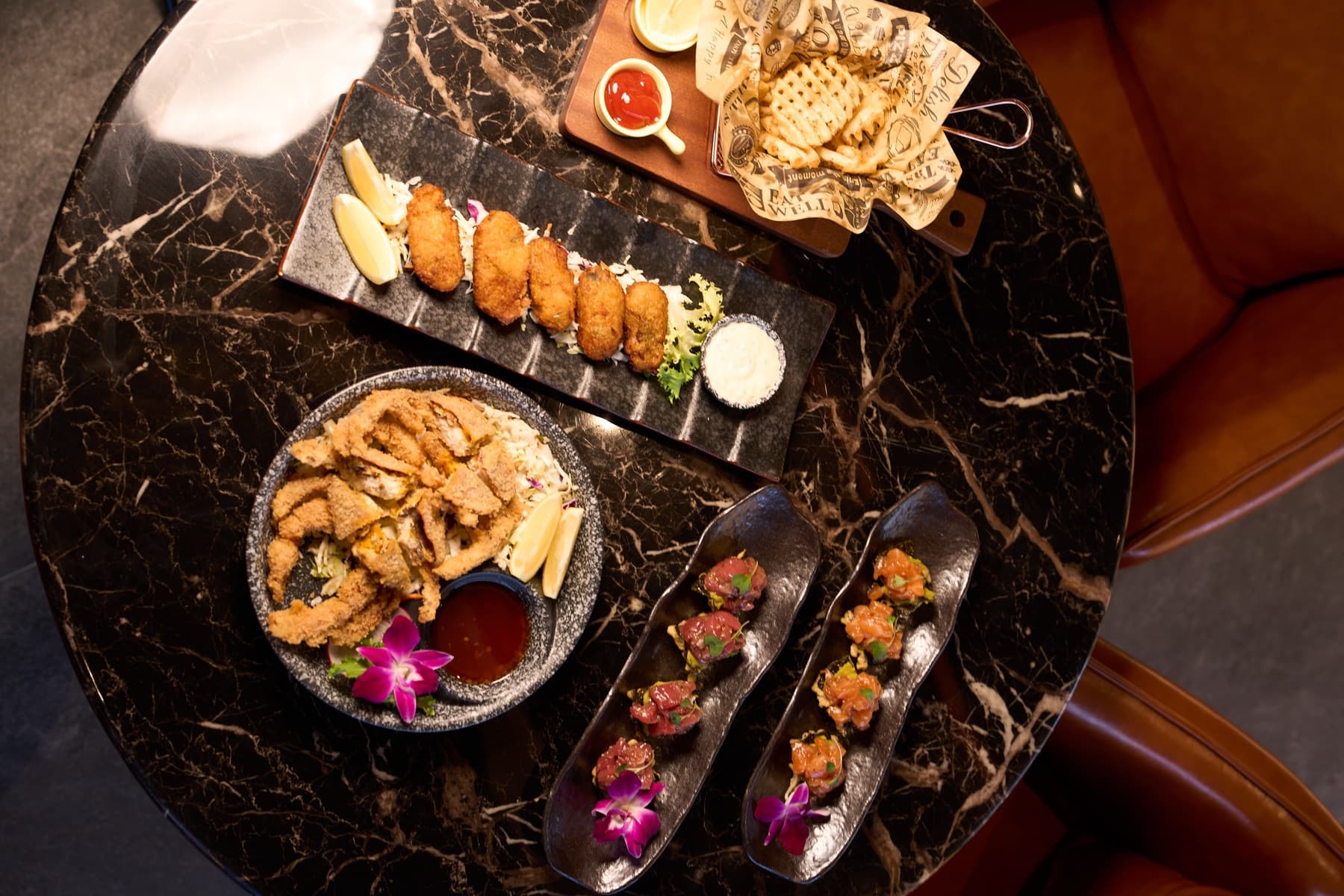 Izakaya spread on a marble lounge table