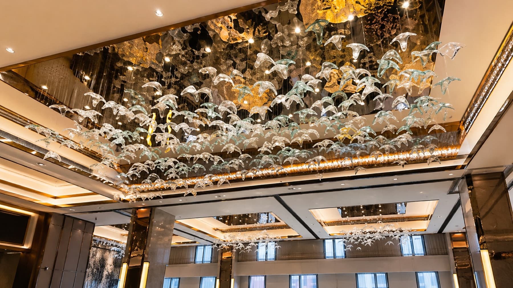 Grand hall with glass-bird ceiling installation