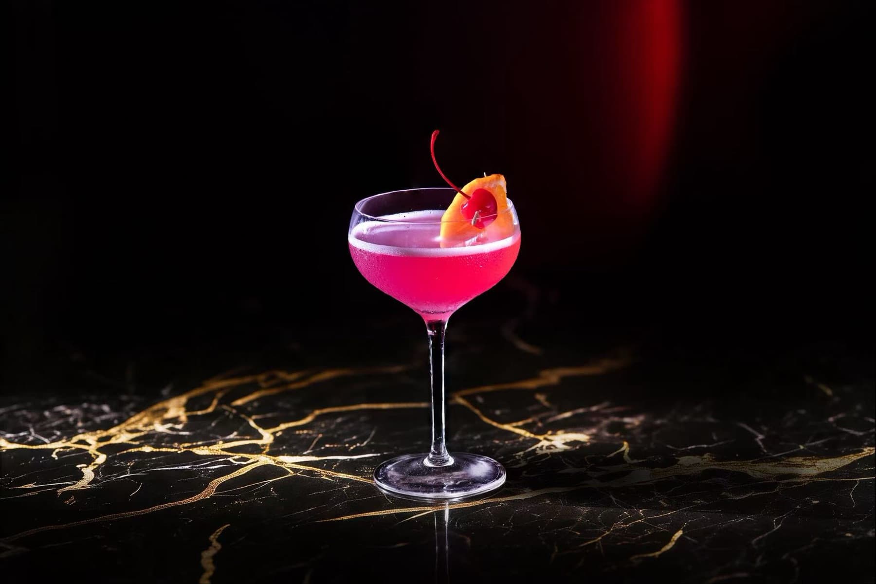 Blossom-pink cocktail on gold-veined marble