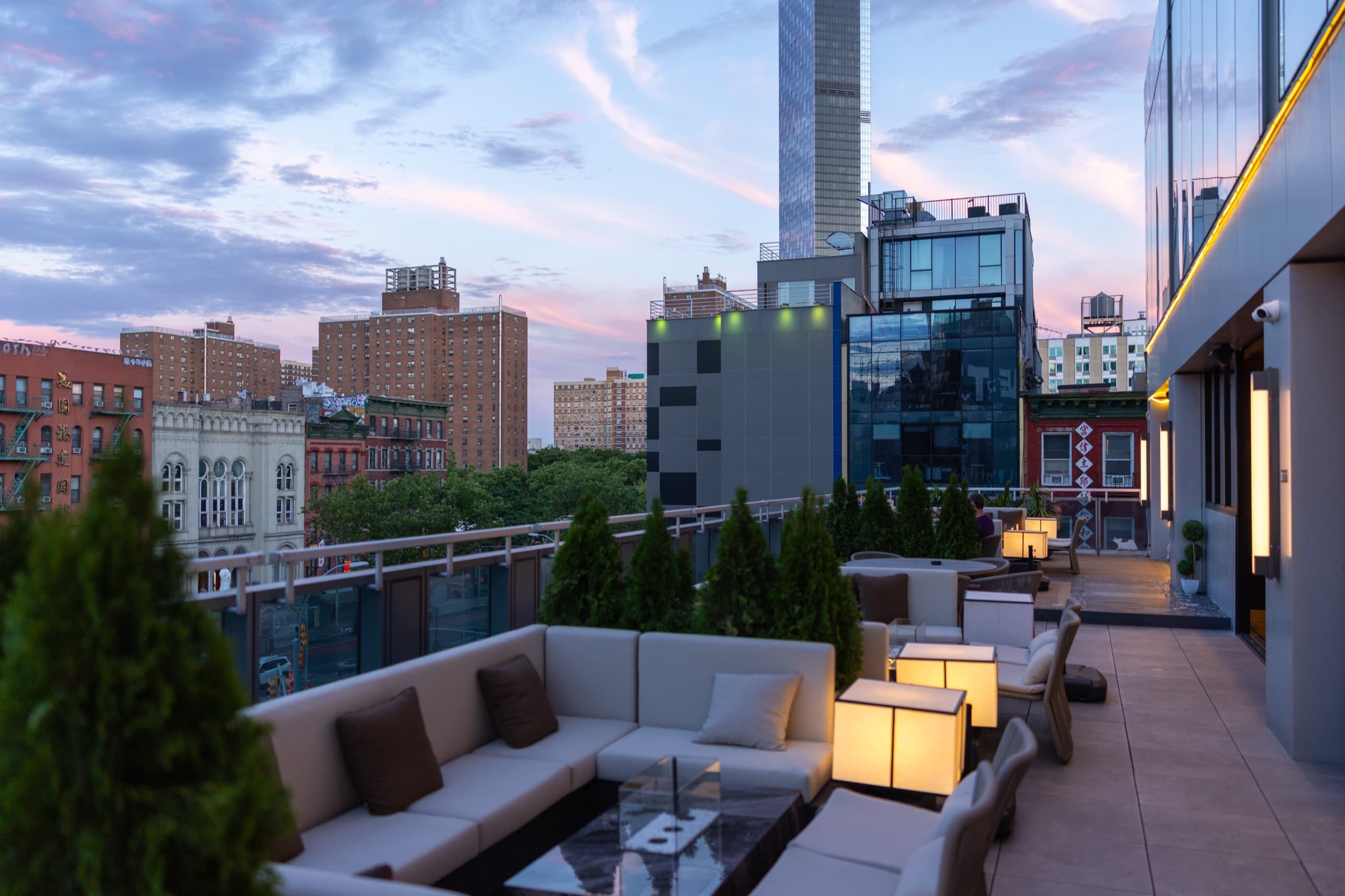 Rooftop terrace at sunset overlooking the city skyline